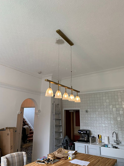 An electrician testing an electrical system for an EICR report.