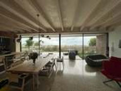 Bright, modern living space with wooden beams and large glass windows.