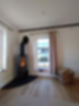 A corner of a room featuring a wood burning stove