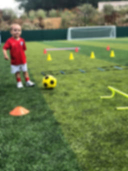 Toddler playing football