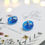 Thumbnail: Translucent blue stud earrings with white flower 'snowflakes'