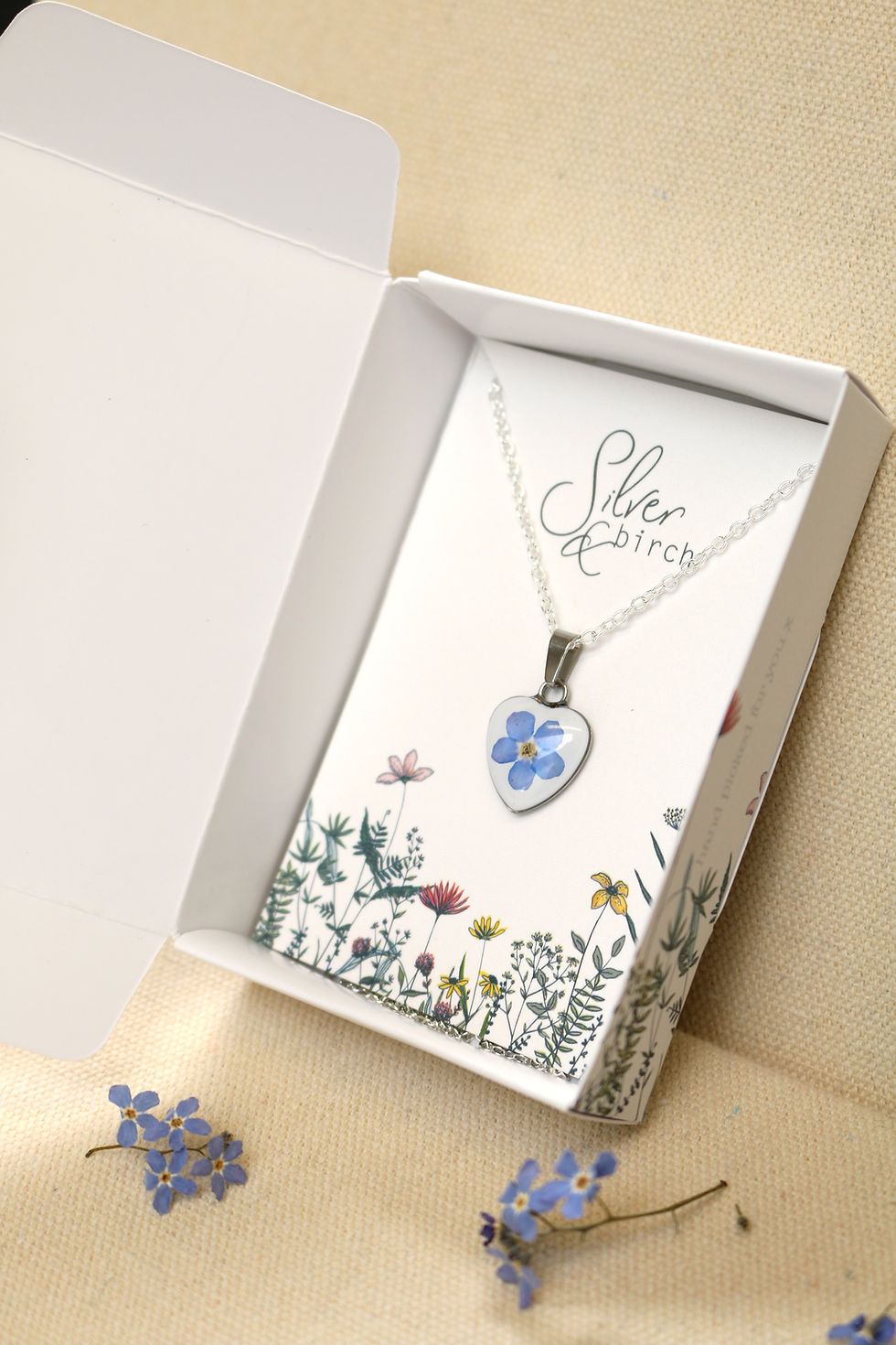 Thumbnail: Silver heart necklace with real forget me not flower