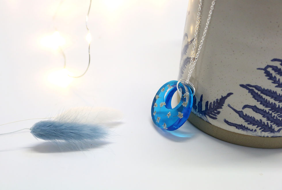 Thumbnail: Translucent blue hoop necklace with white flower 'snowflakes'