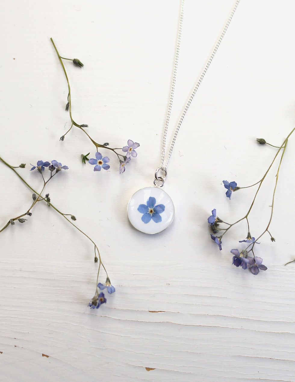 Thumbnail: Sterling silver circle necklace with real blue forget me not flower