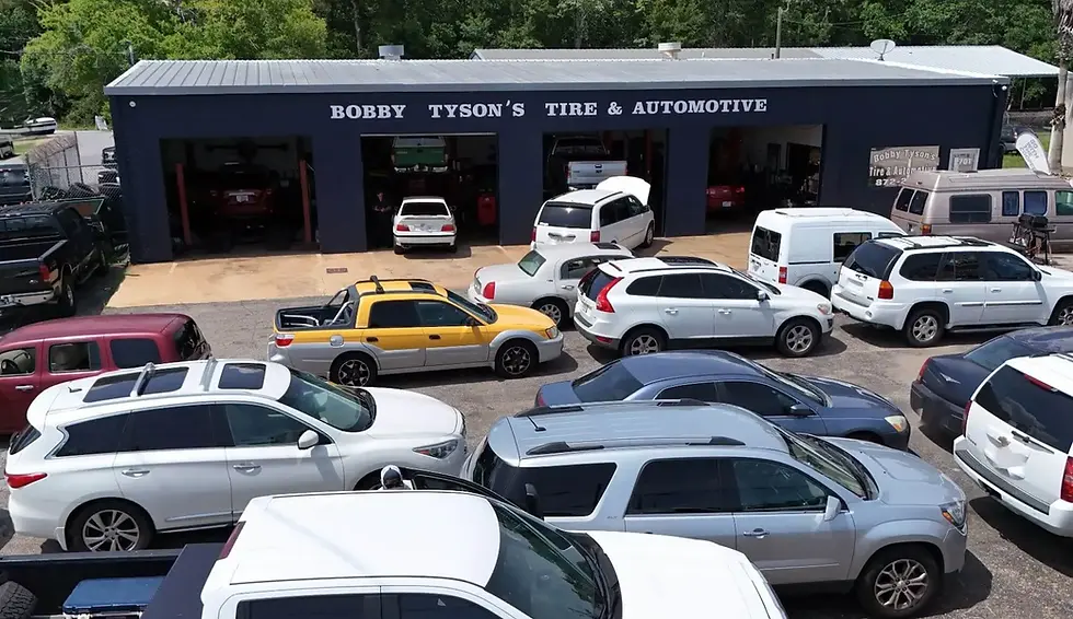 Aerial view of Bobby Tyson’s Tire & Automotive auto repair shop in Ocean Springs, MS with cars in garage bays.