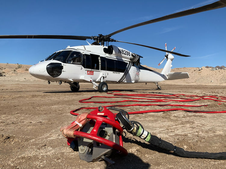 UH-60A in remote desert performing heavy lift operations.