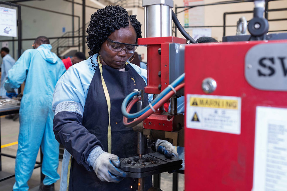 Woman in protective gear operating industrial machinery