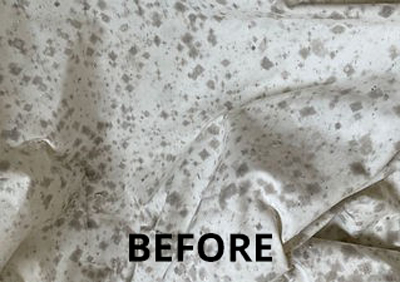 Before image shows stained white fabric with dark gray spots.