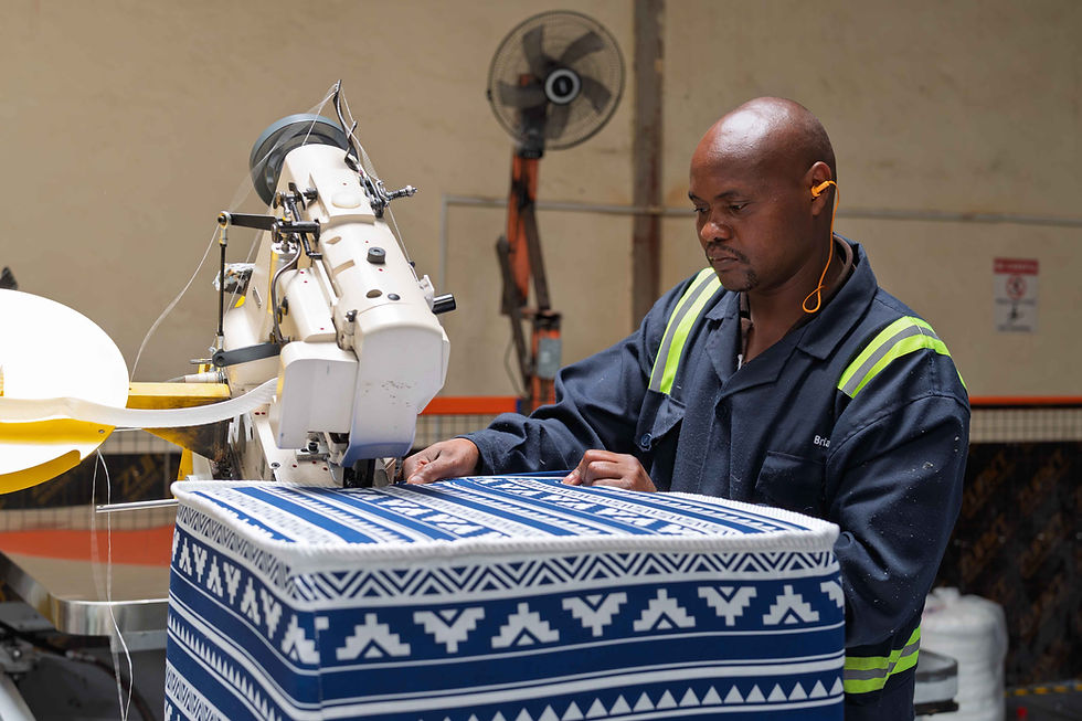Worker using an industrial sewing machine on patterned fabric