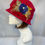 Thumbnail: Red hat with blue flower