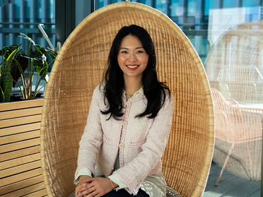 A professional portrait of Hilary Tam, Sustainability Leader for EMEA at Amazon Web Services (AWS), discussing strategic business integration.