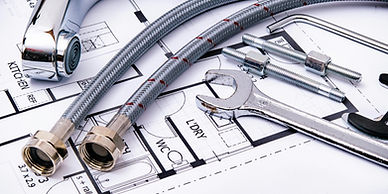 Plumbing tools and faucet on architectural floor plan