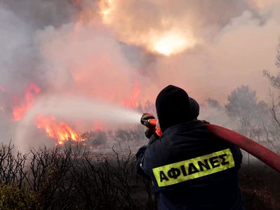Explosions heard as firefighters battle wildfire near Athens