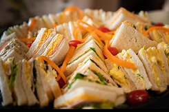 Sandwich Platter with cheese and ham sandwiches cut into triangular quarters.