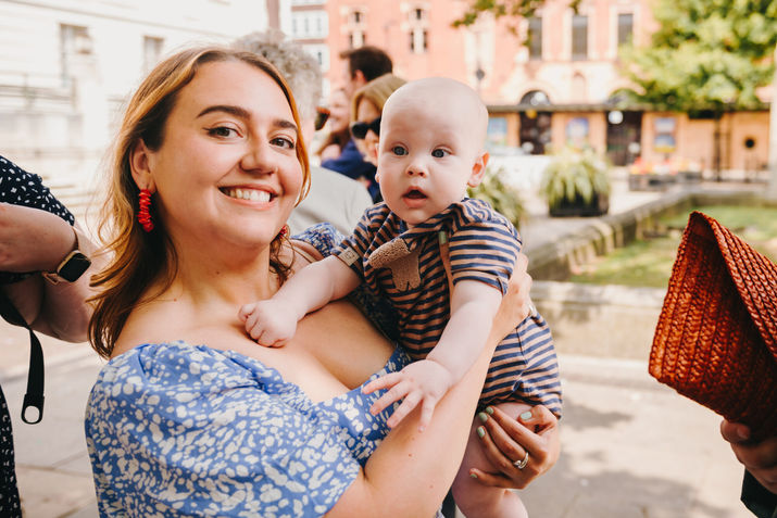 Woman posing while holding a baby. Hackney, London
