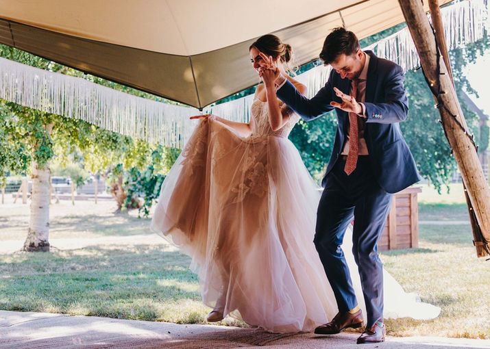 Just married entering the dancing floor. Wedding in a family farm in Hildenborough, Kent.