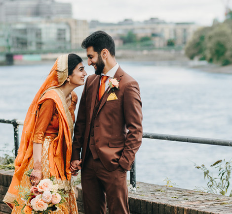 Indian couple with the River Thames in the background.