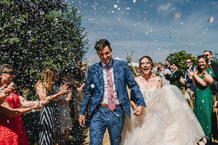 throwing confetti at just married couple, farm wedding in kent.
