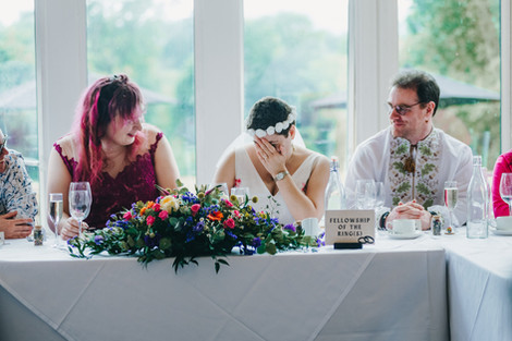 Bride cover her face in the top table.