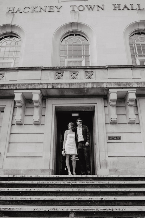 Just married posing at the door of The Hackney Town Hall.