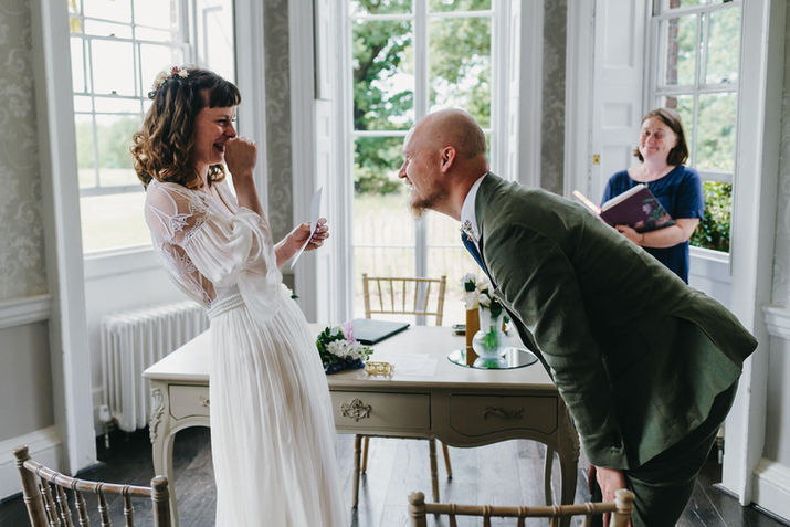 Groom playfully teasing the bride at Merton Register Office, Morden Park House, London.