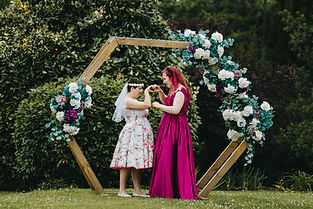 hartsfield-manor-hotel-betchworth-two-brides-hold-hands-under-arch.jpg