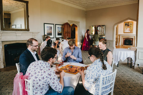 People playing board games. Wedding at Hartsfield Manor Hotel, Betchworth.
