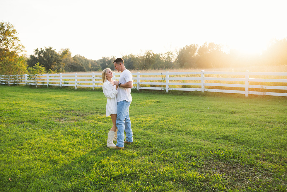 couple slow dancing in an open field during Baton Rouge engagement session 