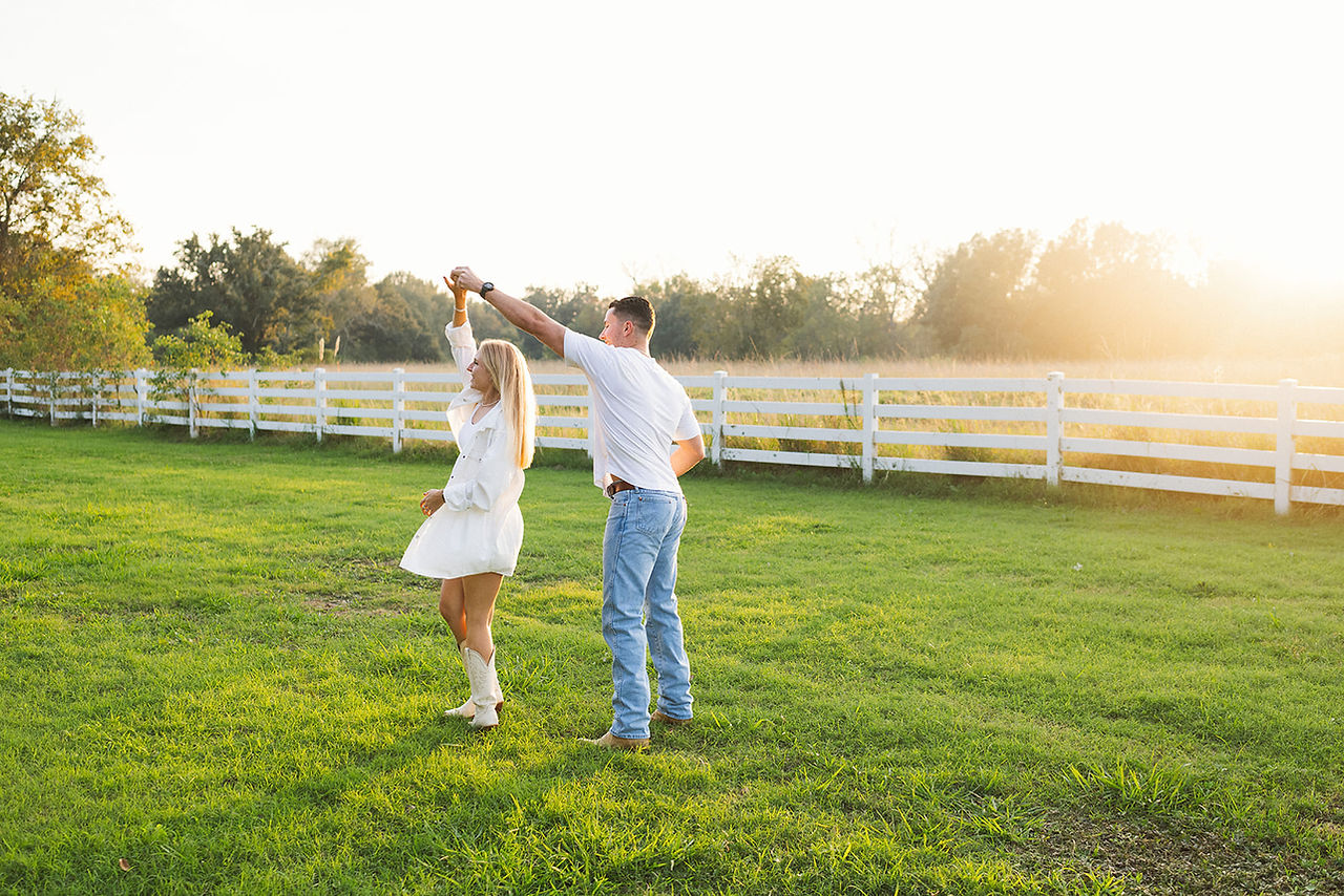 couple slow dancing in an open field during Baton Rouge engagement session