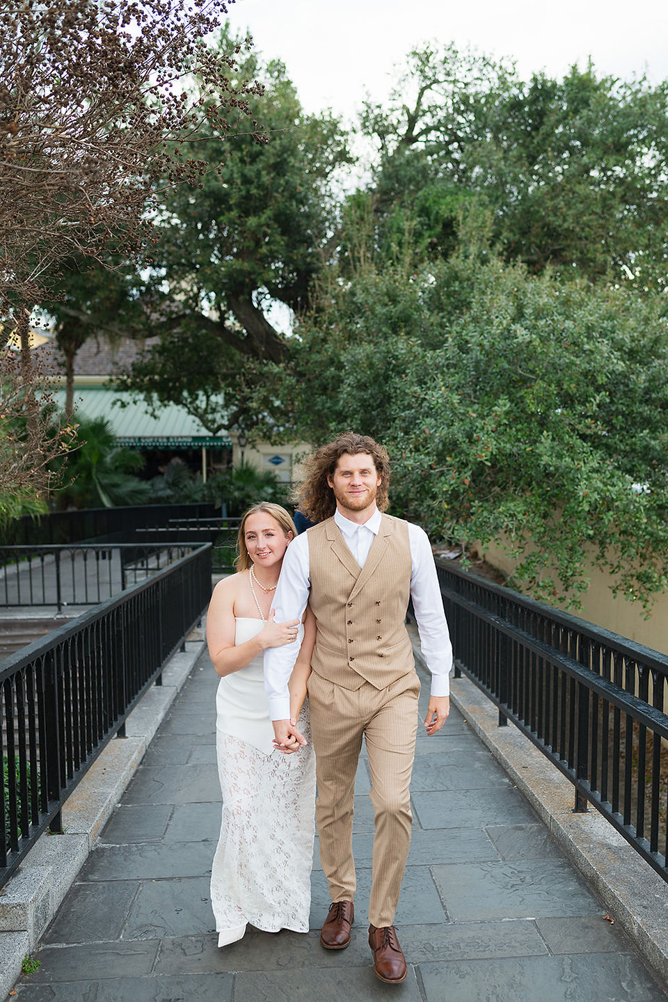 A man and woman walking towards the camera during their New Orleans engagement photos