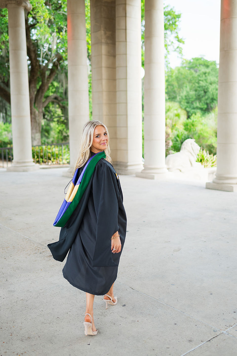 New Orleans PA graduate walking away peeking over her shoulder in New Orleans City Park 