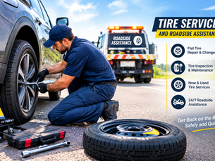 Tire service technician changing a flat vehicle tire during roadside assistance