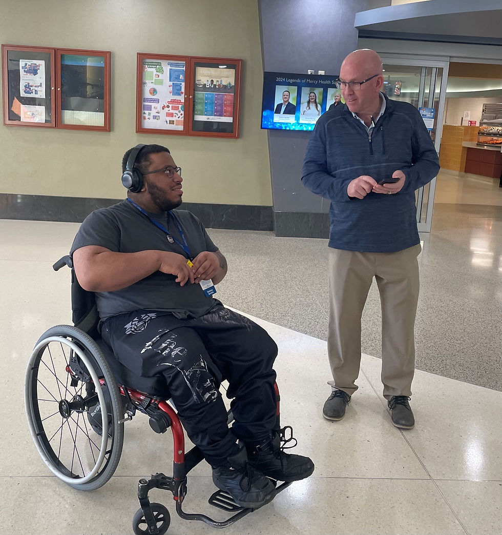 Rico speaking with the executive director of The ARC.