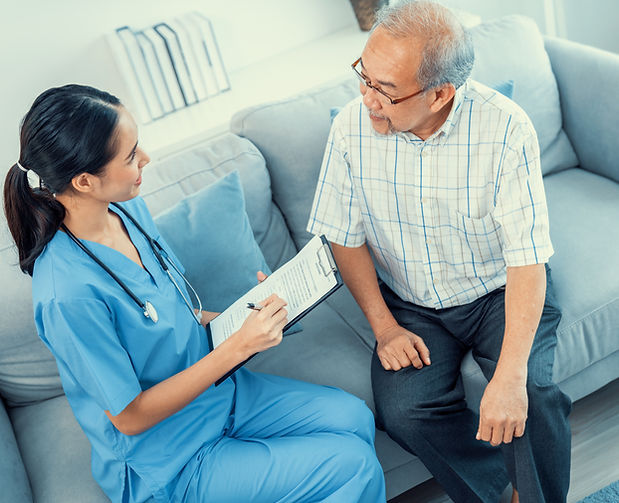 A young female doctor inquires about personal information of a contented senior at home Me