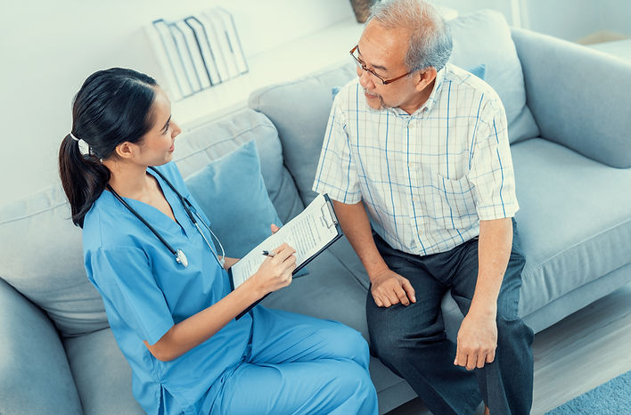 A young female doctor inquires about personal information of a contented senior at home Me