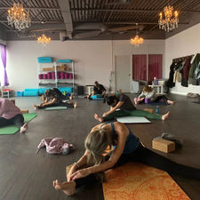 Students actively participating in a yoga class in the spacious and beautiful Life Yoga Studio in Milton