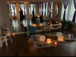 Meditation teacher's setup featuring singing bowls, a practice mat, bells, and a beautiful candle light arrangement at Life Yoga Studio in Milton, Ontario, Canada