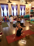 Students practicing the Ashtanga series from their manuals, working diligently towards graduation in the Yoga Teacher Training program at Life Yoga Studio in Milton