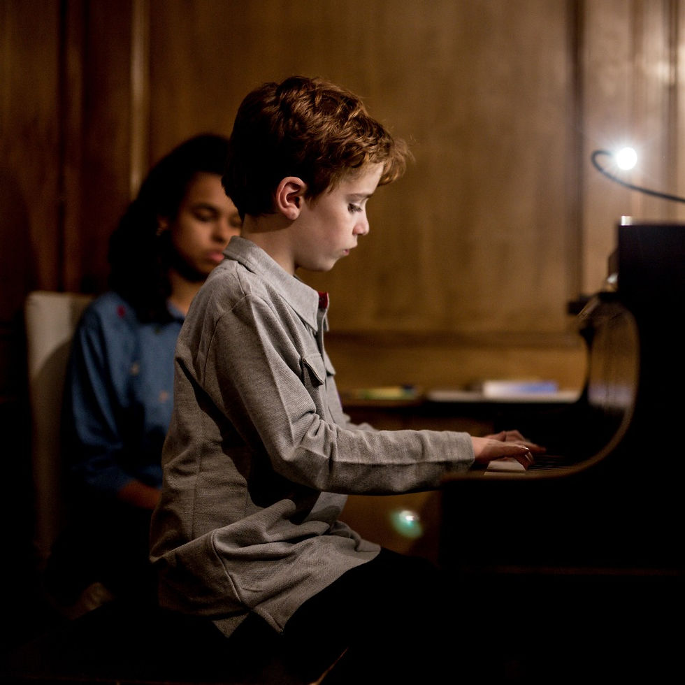 Bailey Grineage conducts piano lesson with a young musician at Upper Beaches Music School in East Toronto