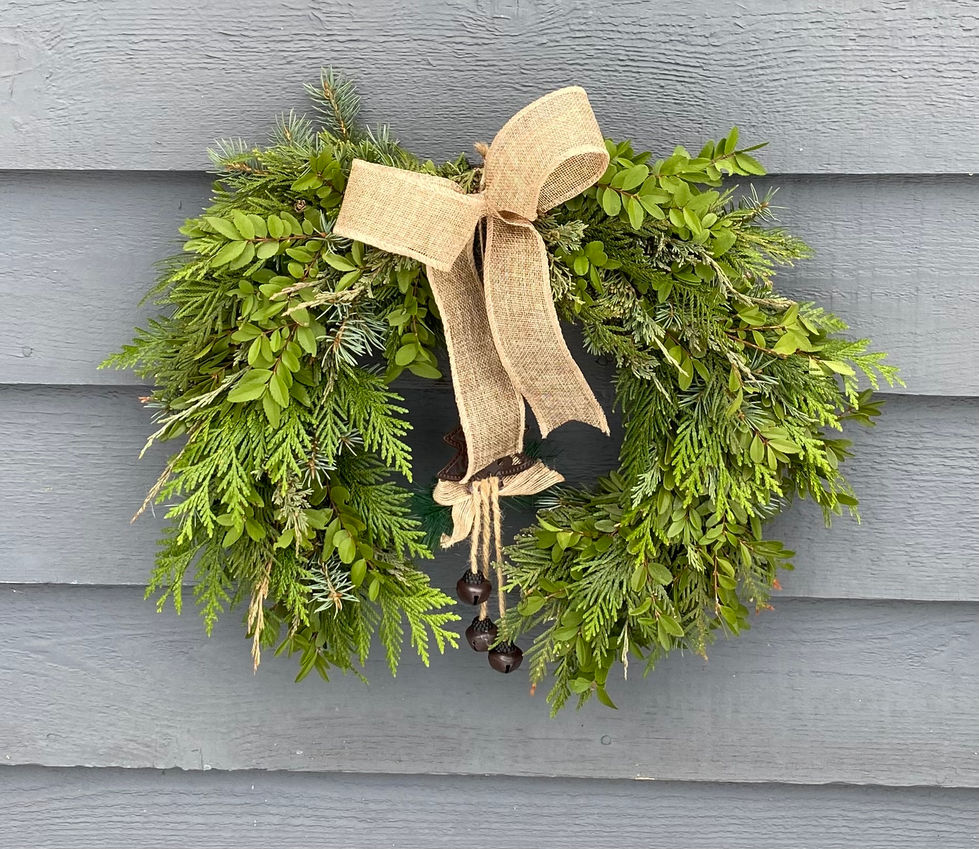 Green evergreen wreath with burlap bow and bells. Seasonal Wreaths and Swags.