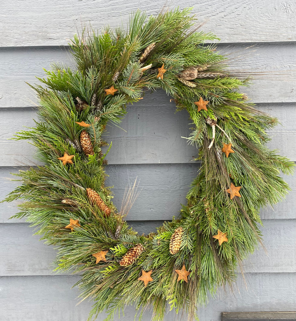 Green pine wreath decorated with star ornaments, pinecones. Seasonal Wreaths and Swags.