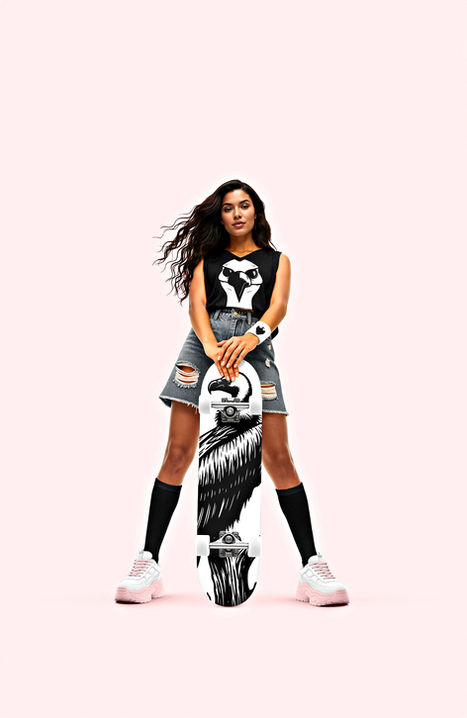 A woman in streetwear holding a 'Proud Vulture' skateboard, standing against a minimalist light pink background.