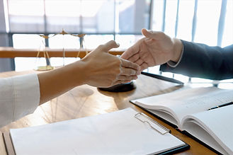 Handshake during a legal meeting, symbolizing Rosi Legal's commitment to client collaboration.