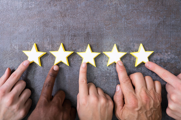 Person Hands Aligning Five Star Rating Icons. High Angle View.jpg