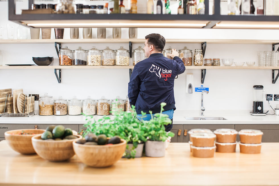 A Blue Tiger employee stocking an office pantry in London