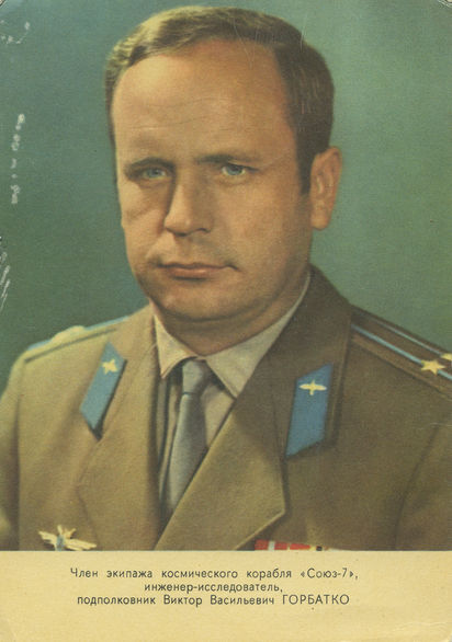 Color archival portrait of a man in a Soviet military uniform against a green background.