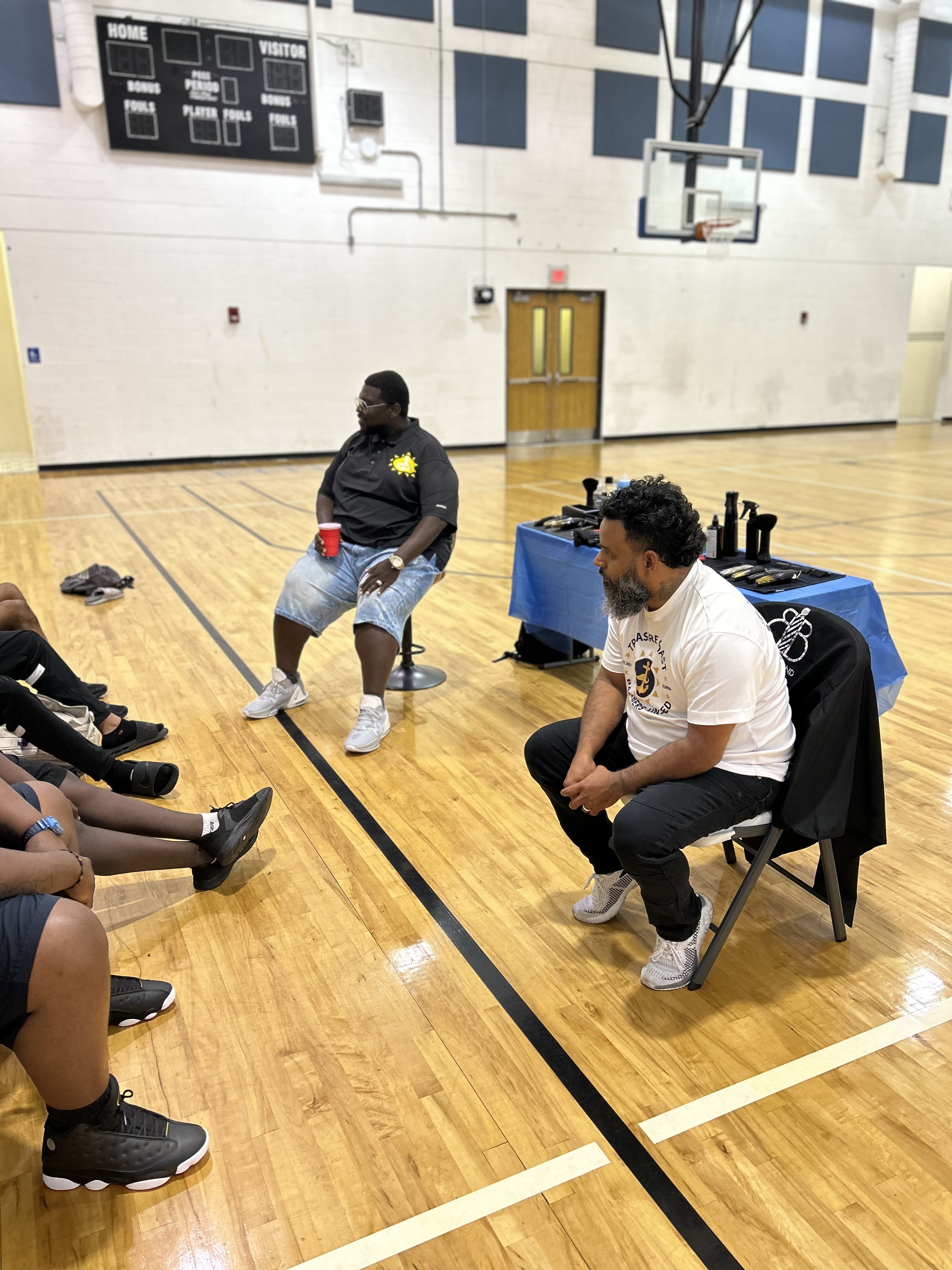 Gregory L. Jones and Jieomar Rivera speaking with the youth at Percy Peek Boys and Girls Club