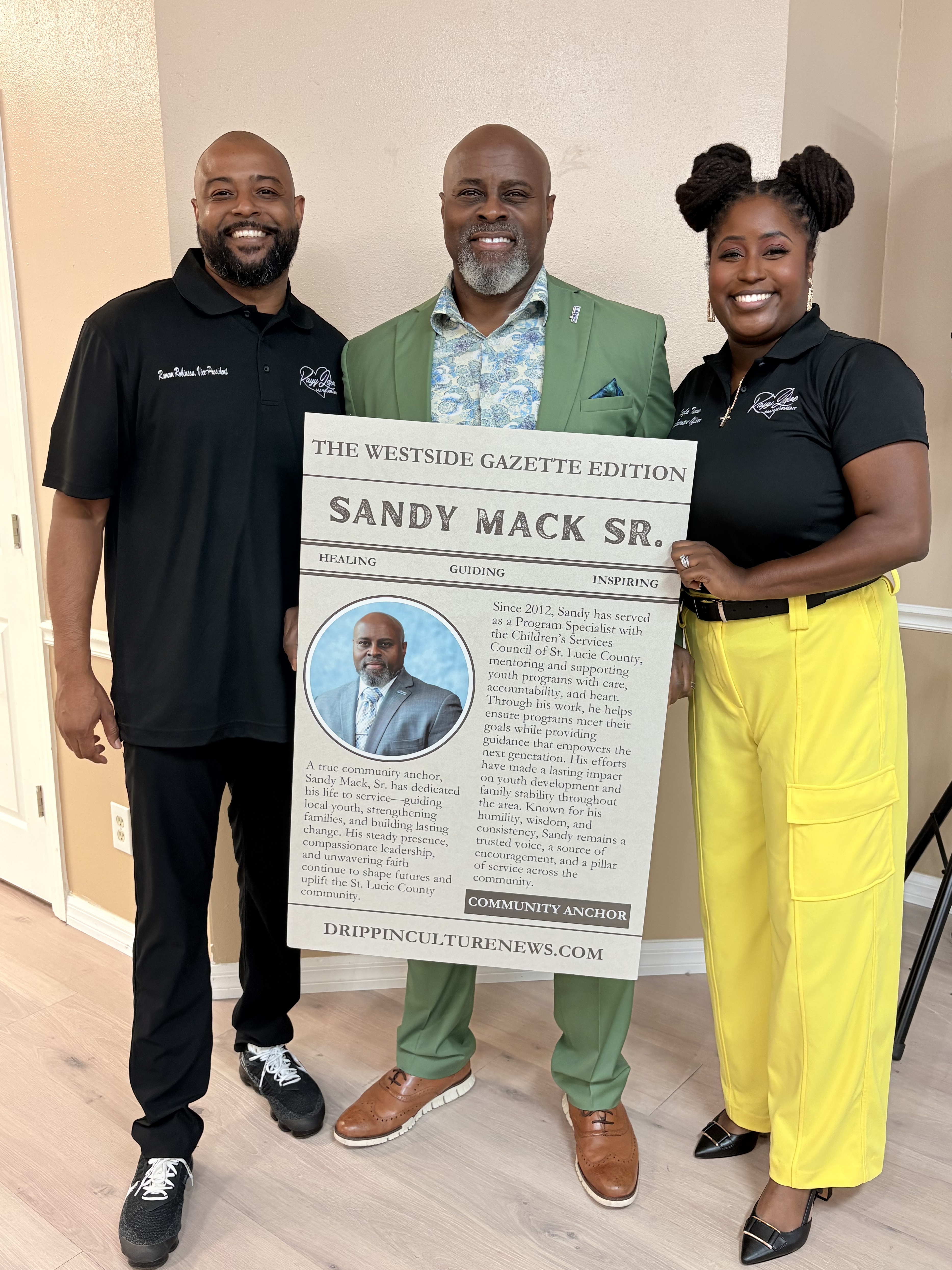 Ramon Robinson and Kalya Turner posing with trading card recipient Sandy Mack, Sr.