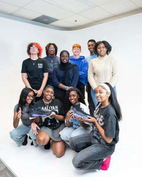 Students showing EQLZ 247 basketball shoe