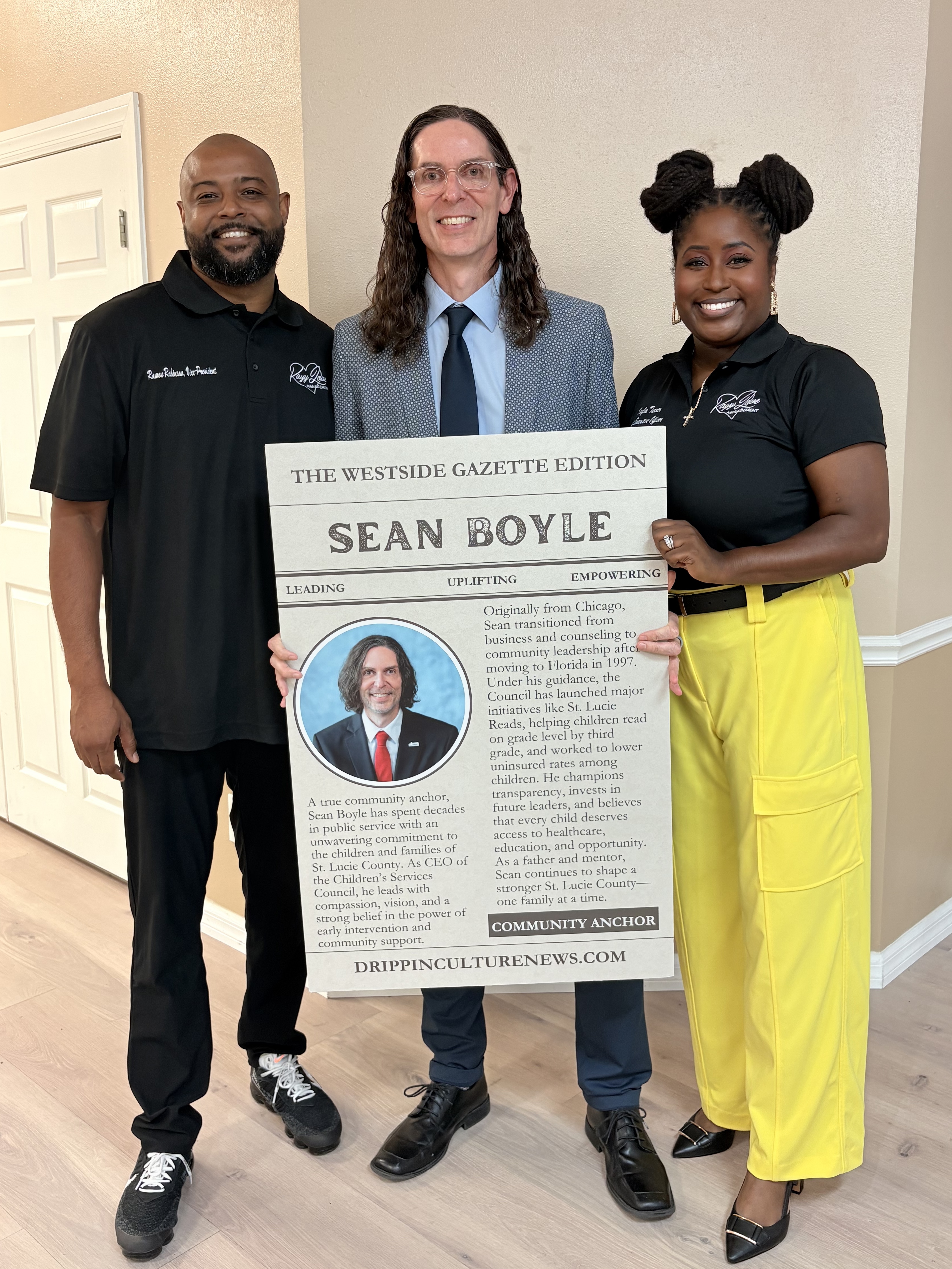 Ramon Robinson and Kalya Turner posing with trading card recipient Sean Boyle
